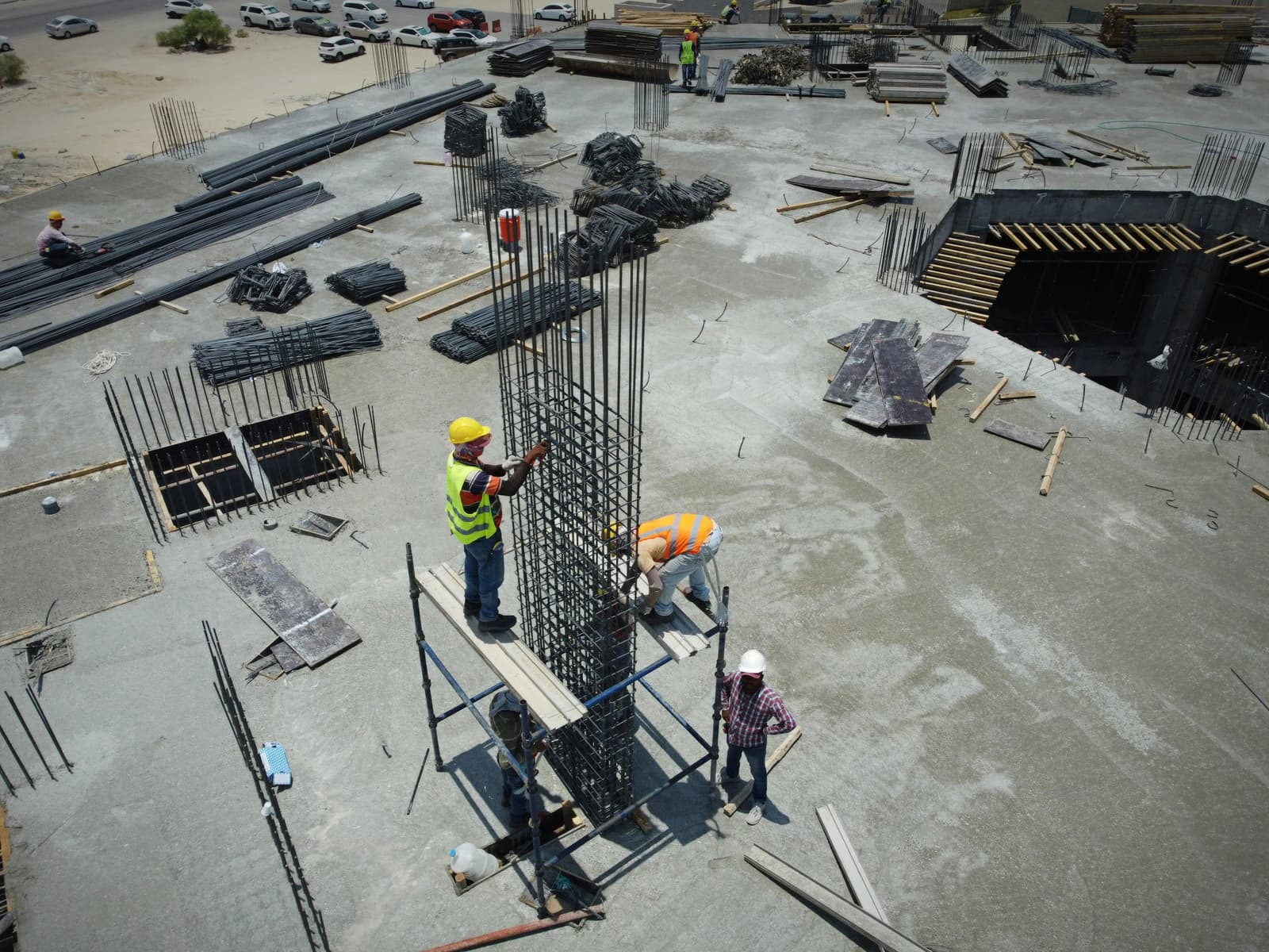 Workers fixing reinforcement on an active construction site, seen from above